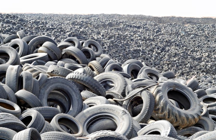 Image of piles of tires in a vast ground